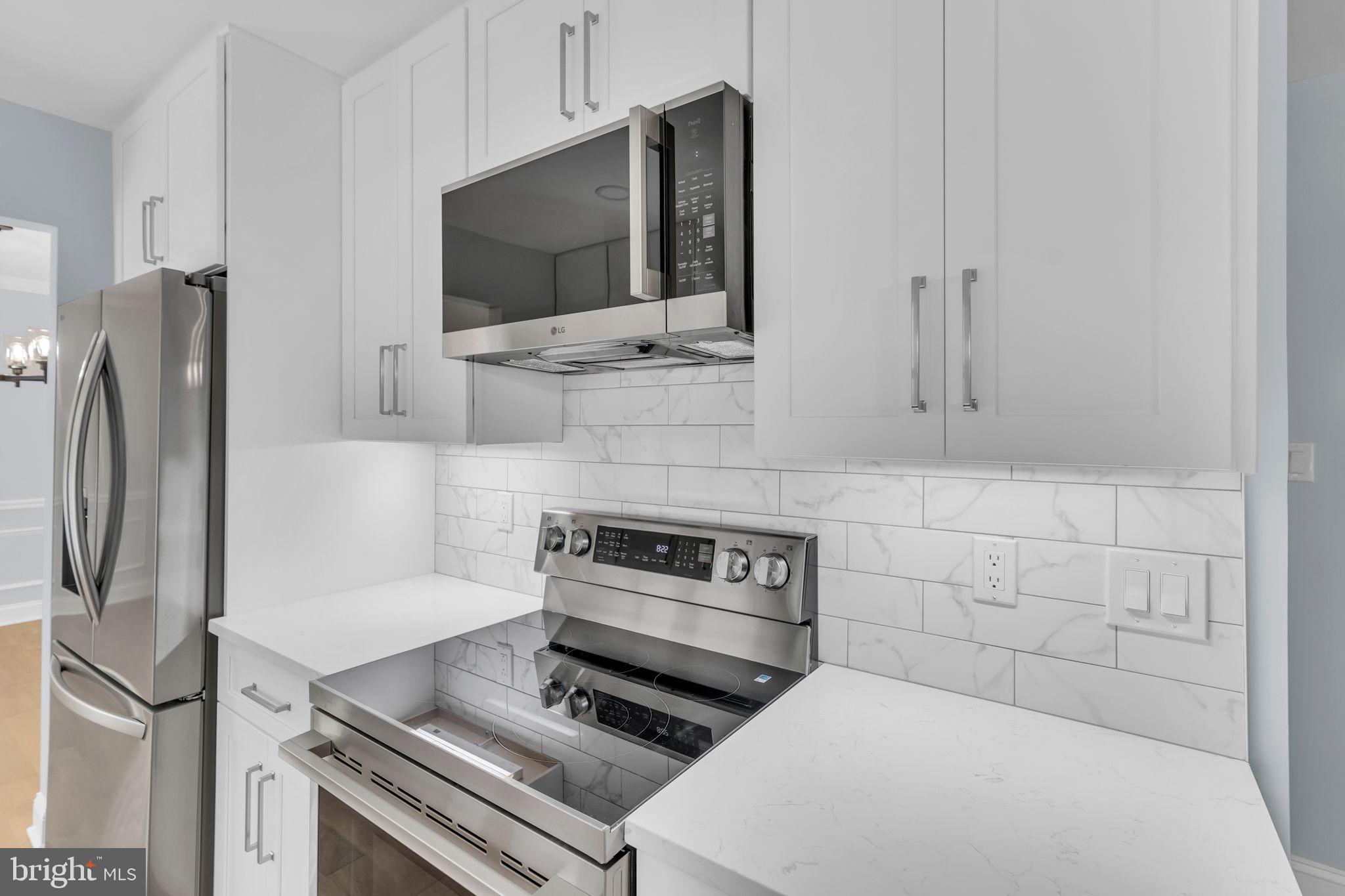 7804 Carrleigh Parkway Springfield, VA 22152 - Photo 19 of 61 a kitchen with stainless steel appliances a refrigerator and a stove top oven