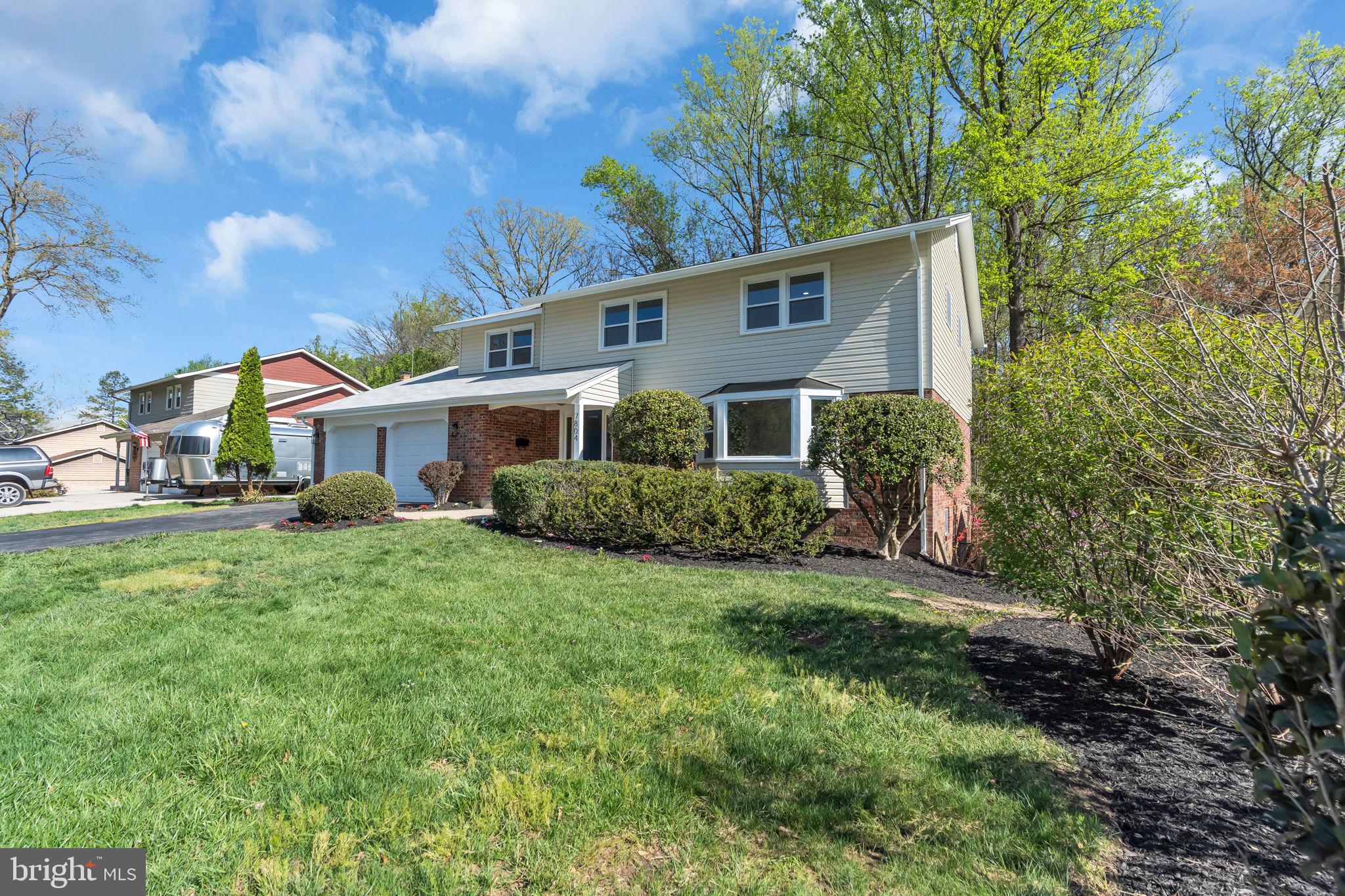 7804 Carrleigh Parkway Springfield, VA 22152 - Photo 2 of 61 a front view of a house with a yard