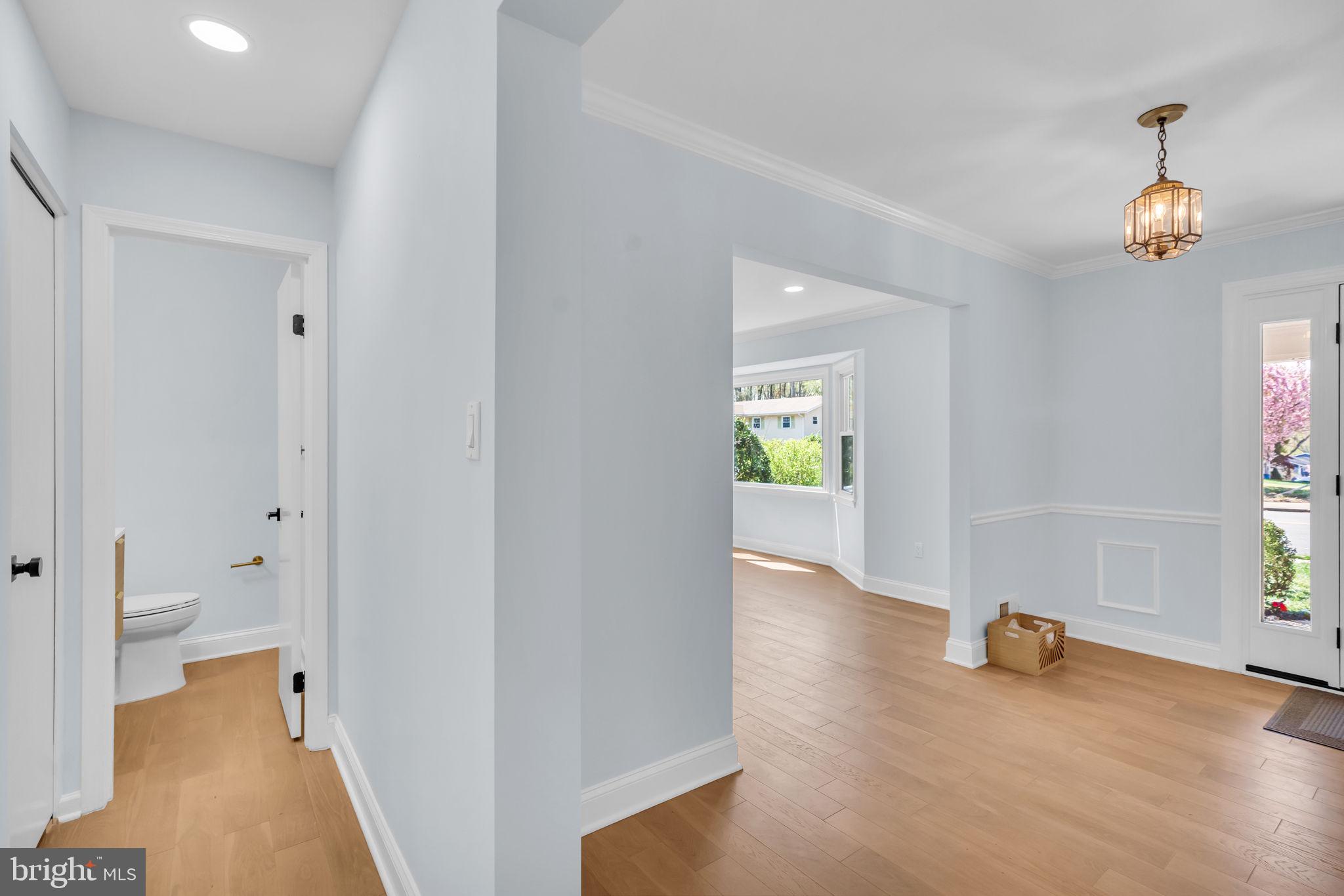 7804 Carrleigh Parkway Springfield, VA 22152 - Photo 29 of 61 a view of a hallway with wooden floor and a living room