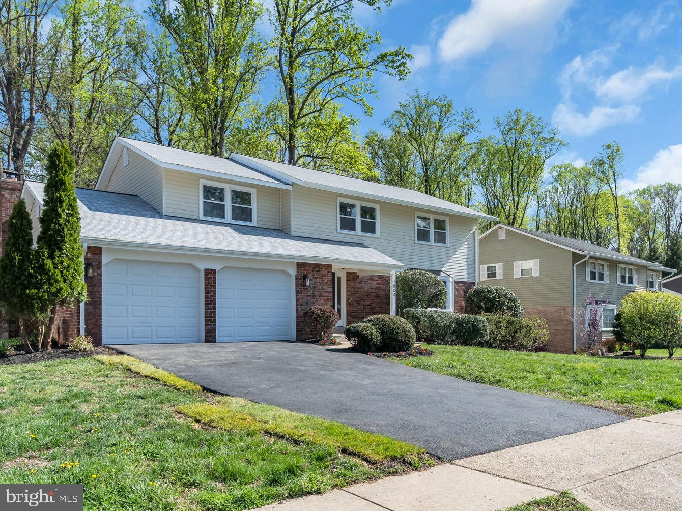 7804 Carrleigh Parkway Springfield, VA 22152 - Photo 4 of 61 a front view of a house with a garden