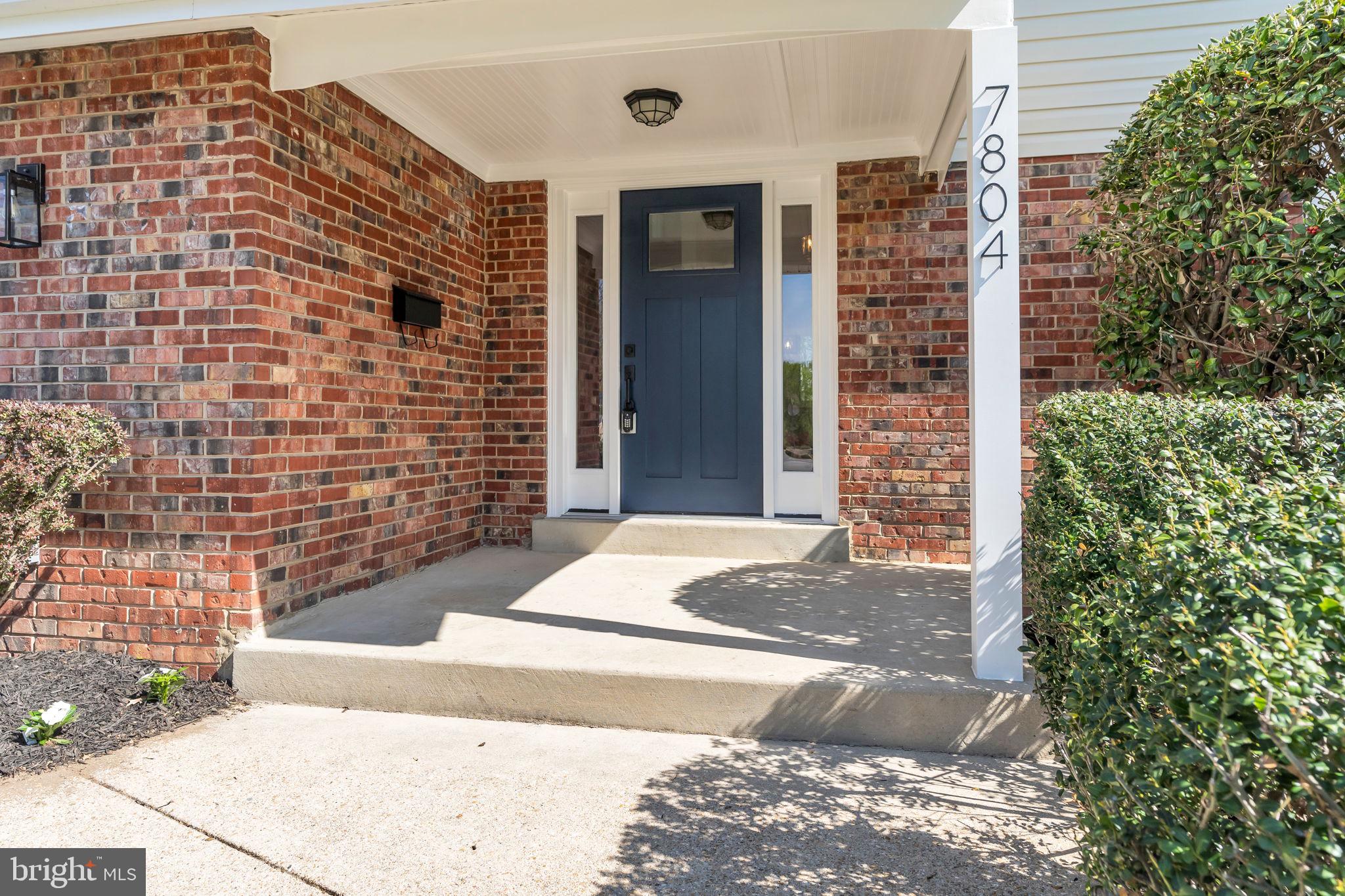 7804 Carrleigh Parkway Springfield, VA 22152 - Photo 5 of 61 a front view of a house with a yard