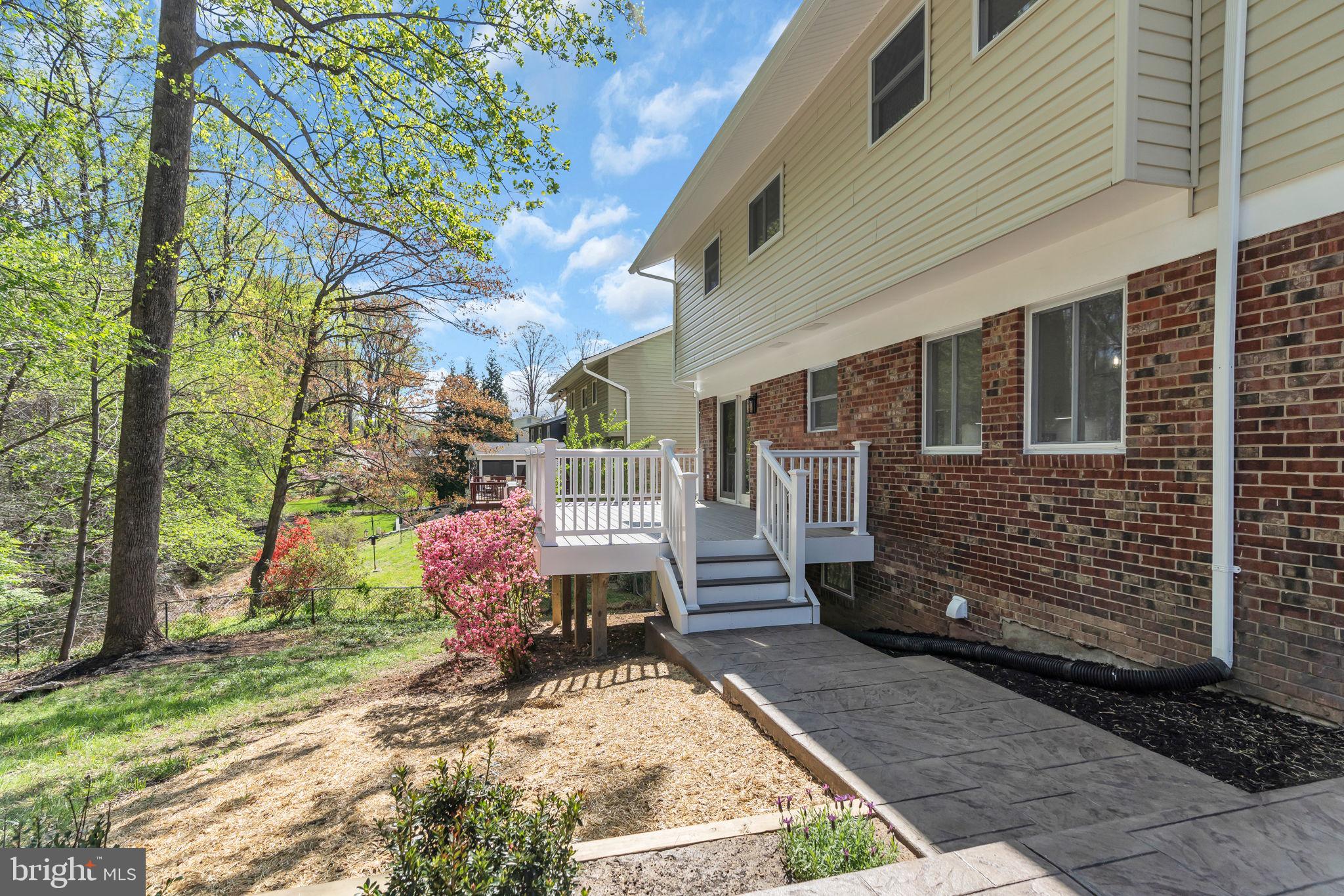 7804 Carrleigh Parkway Springfield, VA 22152 - Photo 53 of 61 a view of a patio with a table chairs and a fire pit