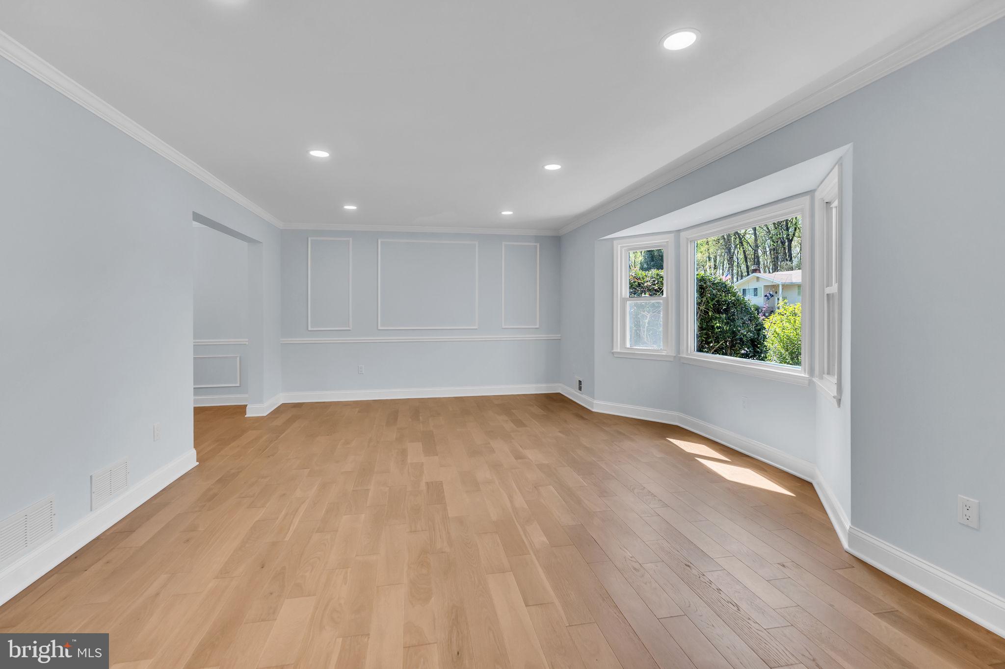7804 Carrleigh Parkway Springfield, VA 22152 - Photo 7 of 61 a view of an empty room with wooden floor and a window
