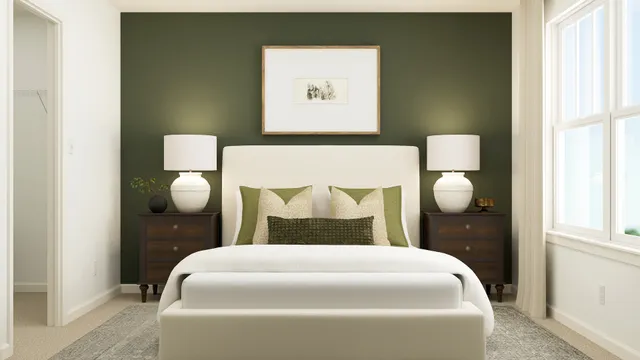 a bedroom with a bed and painting on the wall