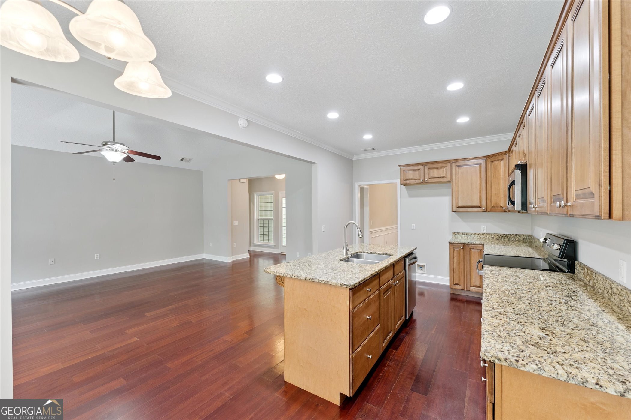 45 Veranda Trail Midway, GA 31320 - Photo 11 of 32 a kitchen with stainless steel appliances granite countertop a sink a stove and a wooden floors