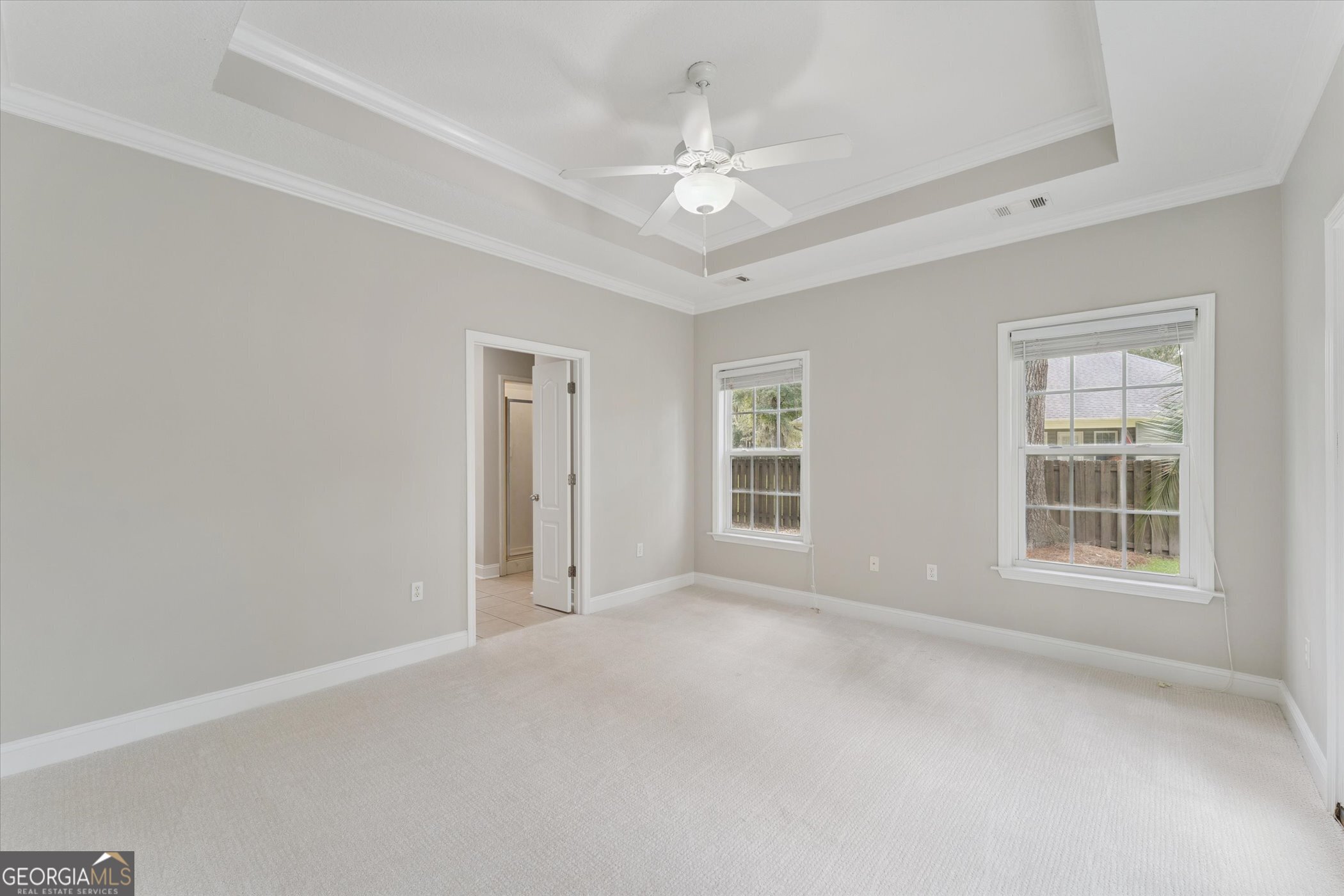 45 Veranda Trail Midway, GA 31320 - Photo 25 of 32 an empty room with windows and chandelier fan