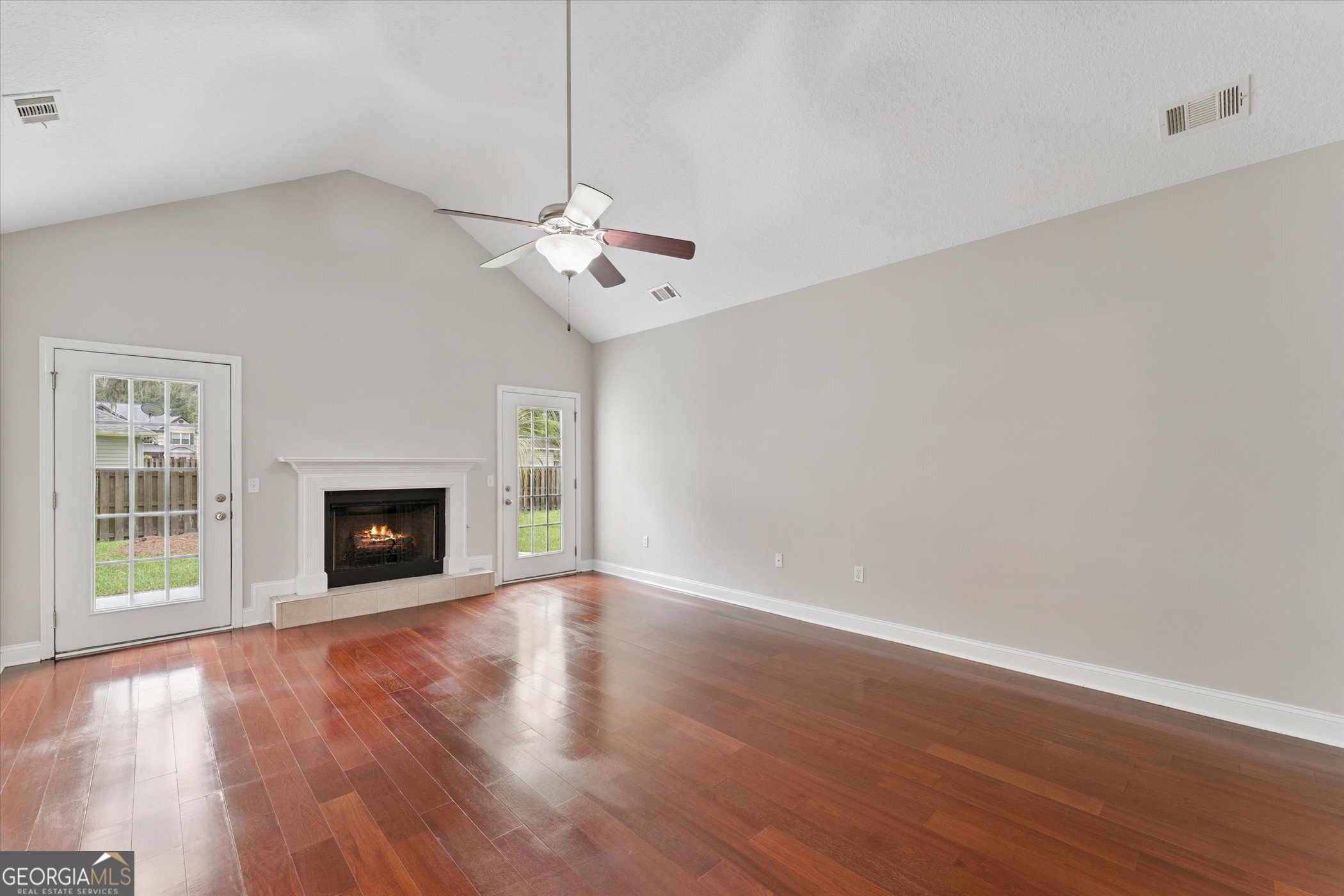 45 Veranda Trail Midway, GA 31320 - Photo 4 of 32 a view of an empty room with wooden floor fireplace and a window
