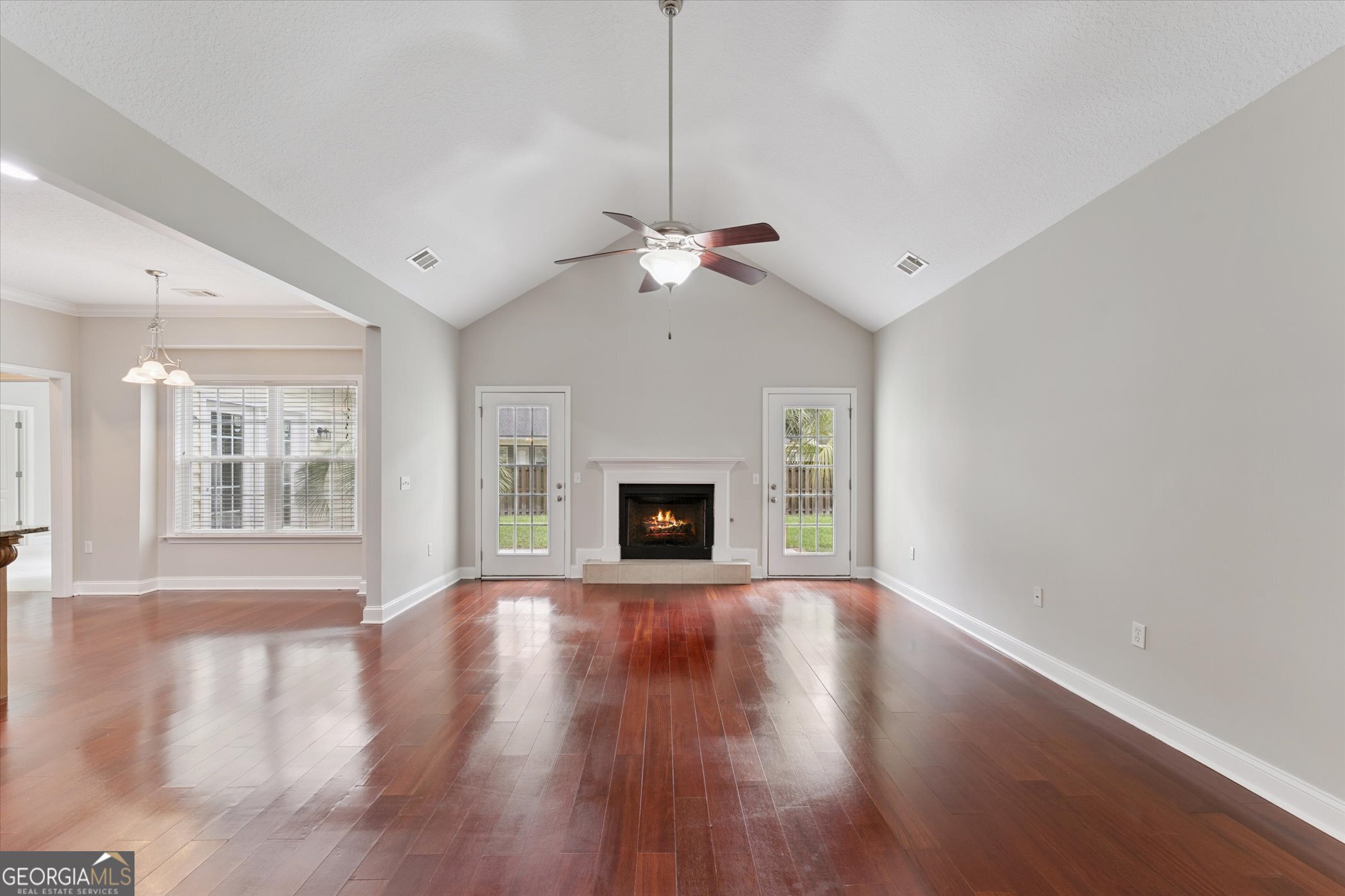 45 Veranda Trail Midway, GA 31320 - Photo 5 of 32 a view of an empty room with wooden floor fireplace and a window