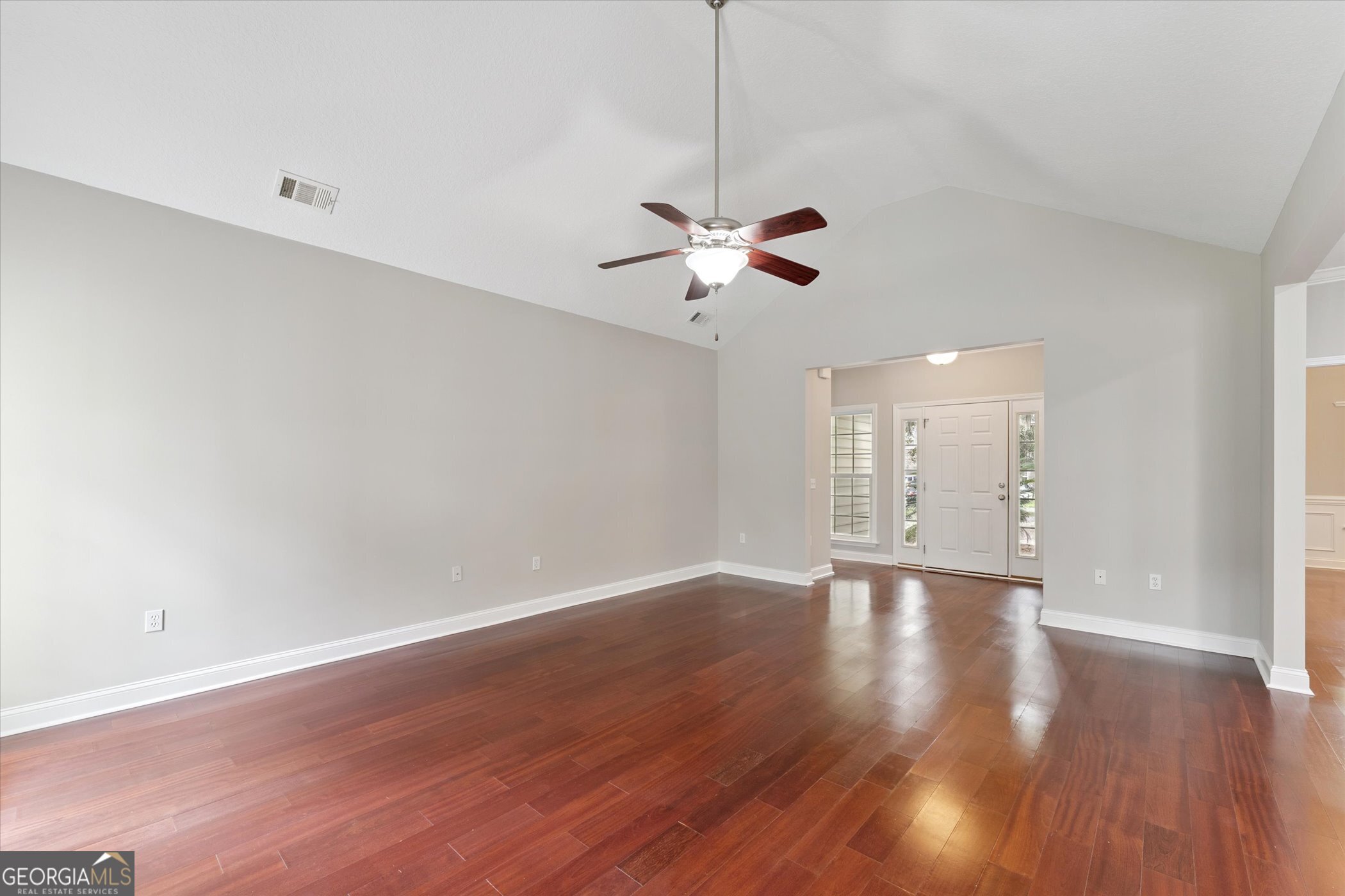 45 Veranda Trail Midway, GA 31320 - Photo 7 of 32 a view of an empty room with a ceiling fan and wooden floor