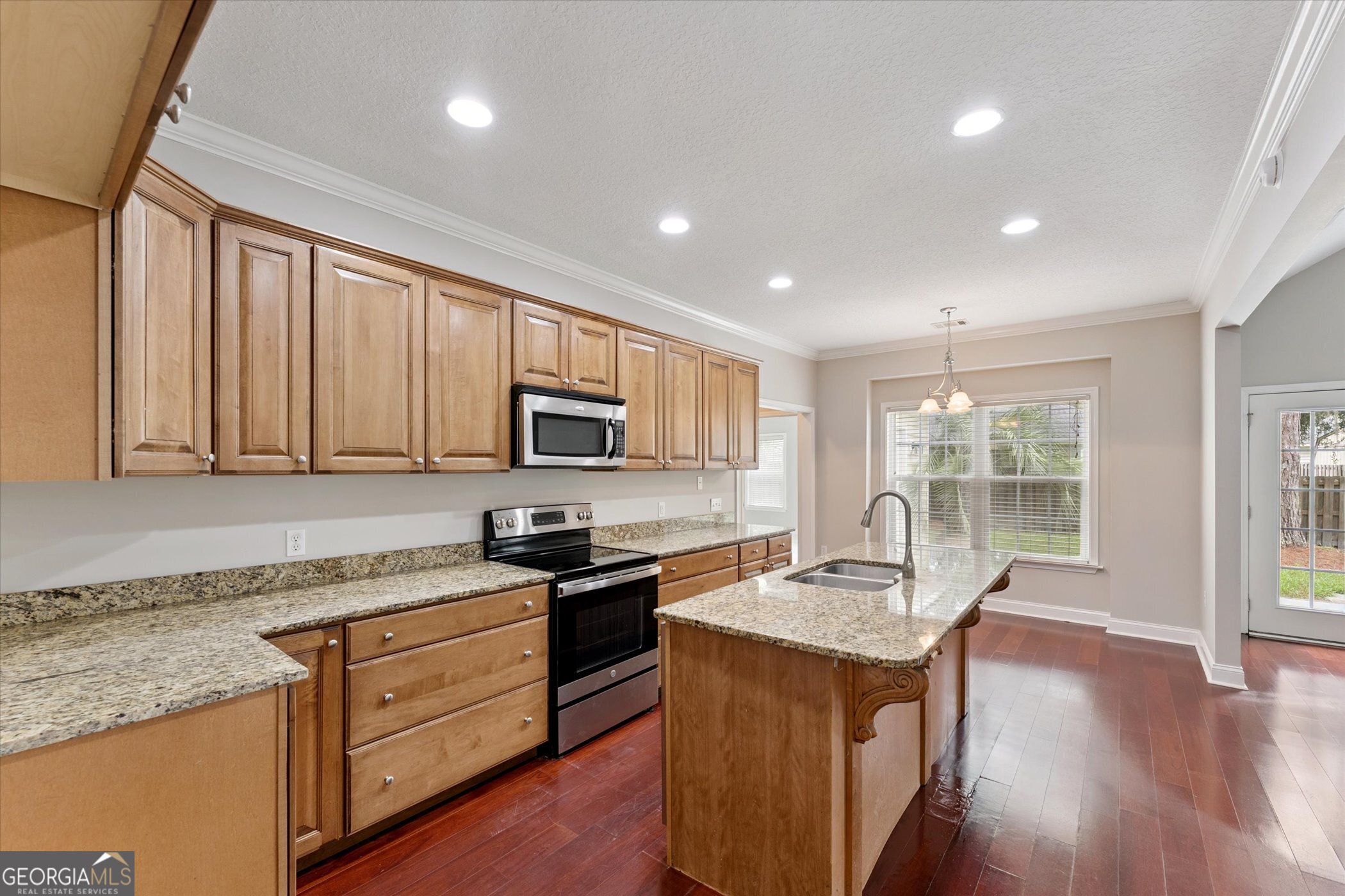 45 Veranda Trail Midway, GA 31320 - Photo 9 of 32 a kitchen with stainless steel appliances granite countertop a sink stove and microwave