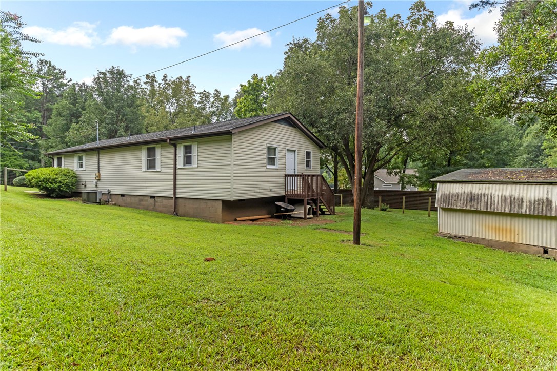 404 Davis Road Liberty, SC 29657 - Photo 36 of 39 A well-maintained lawn surrounds this charming home with a separate storage shed, perfect for outdoor essentials.