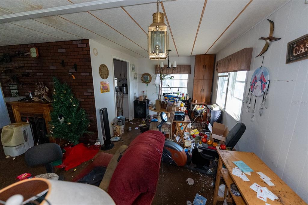 24971 Northeast 135th Street Salt Springs, FL 32134 - Photo 42 of 49 a living room with furniture a dining table and chairs