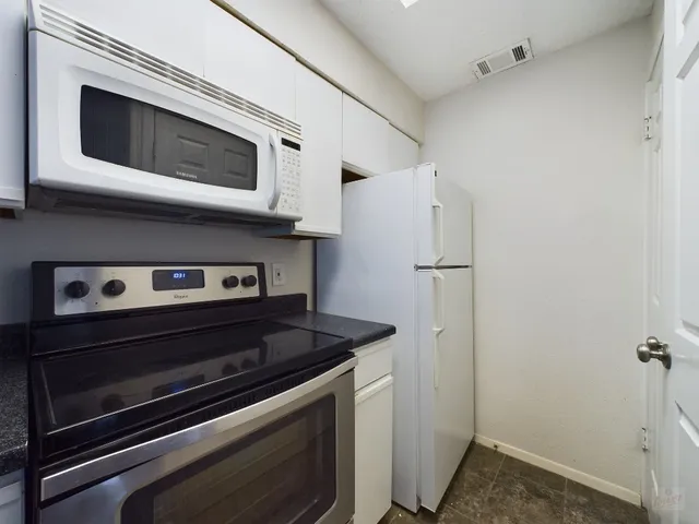 a kitchen with stainless steel appliances granite countertop a sink and a stove