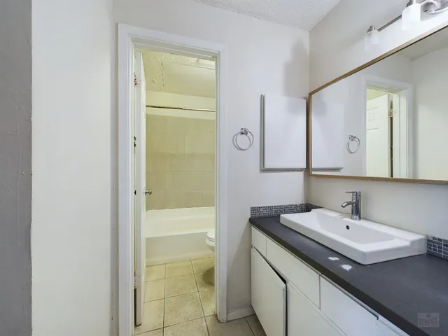 a white bath tub sitting next to a toilet