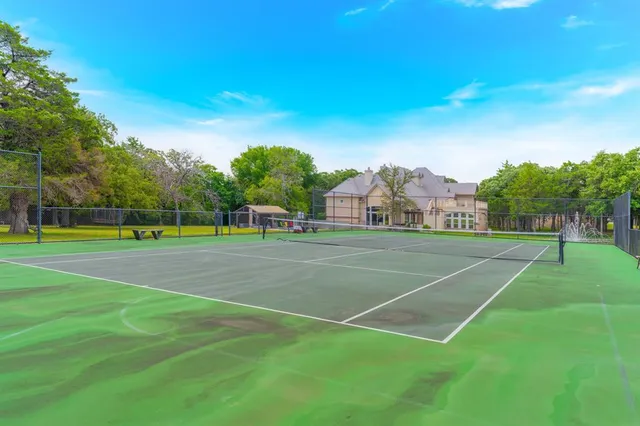a living room with furniture a fireplace and a floor to ceiling window