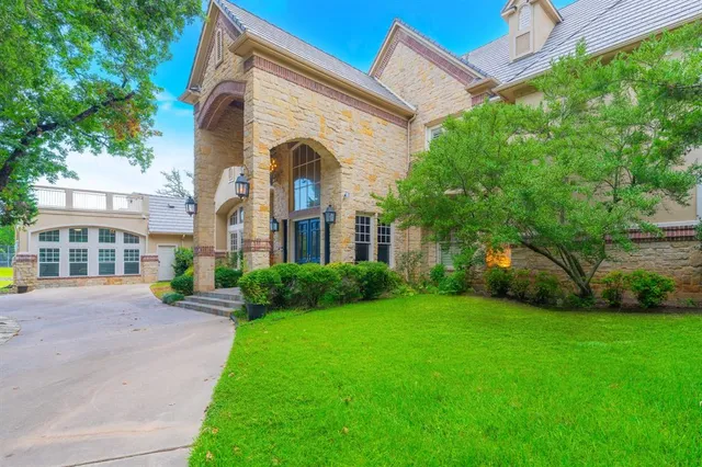 a living room with furniture a potted plant and a chandelier