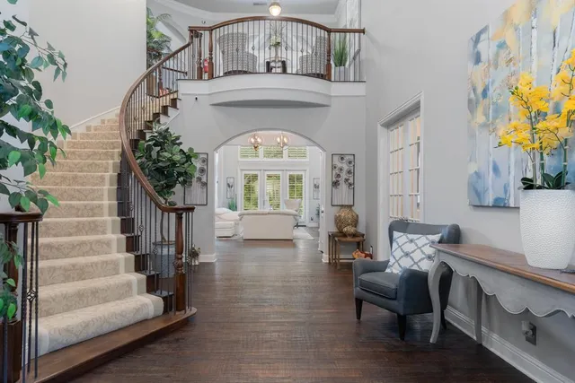 a living room with furniture a fireplace and wooden floor