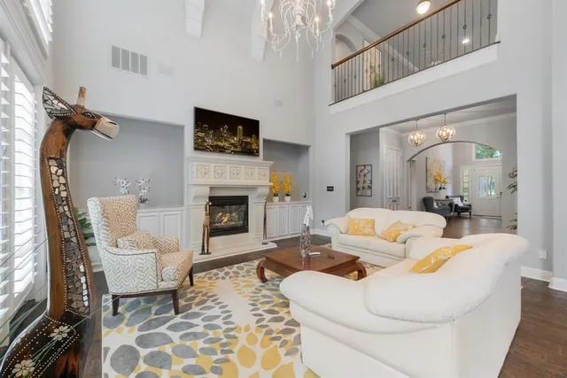 a kitchen with stainless steel appliances granite countertop a table chairs stove a sink dishwasher a refrigerator and a dining table with wooden floor