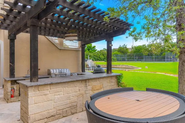 a view of a chairs and table in patio with a yard