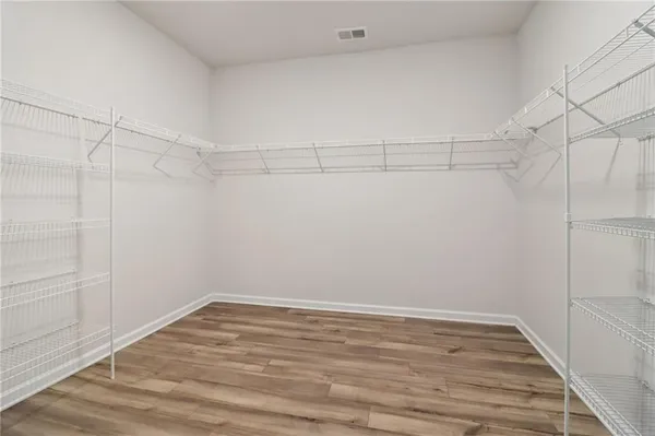 a view of a room with wooden floor
