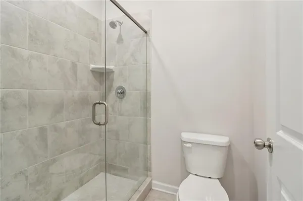 a bathroom with a toilet and shower