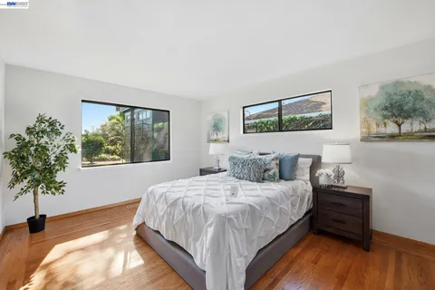 a bed sitting in a bedroom next to a window