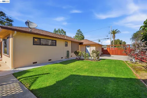 a view of a garden with a building in the background