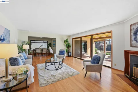 a living room with furniture couches and a potted plant