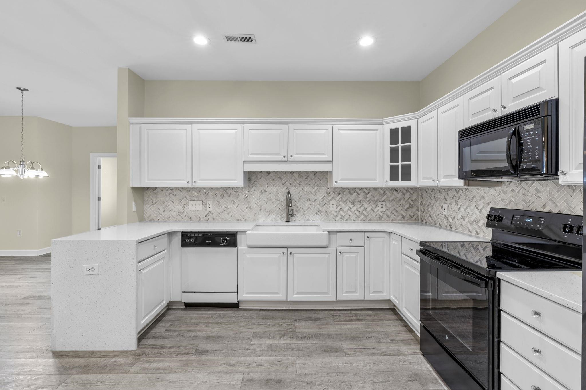 603 Rigside Place, Unit C Cary, NC 27511 - Photo 11 of 30 An Abundance of Timeless White Cabinetry and Touch Faucet in Farmhouse Sink