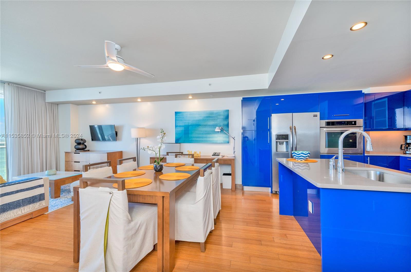 a large kitchen with kitchen island a large counter space and stainless steel appliances