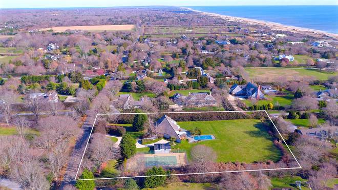 an aerial view of residential houses with outdoor space and swimming pool