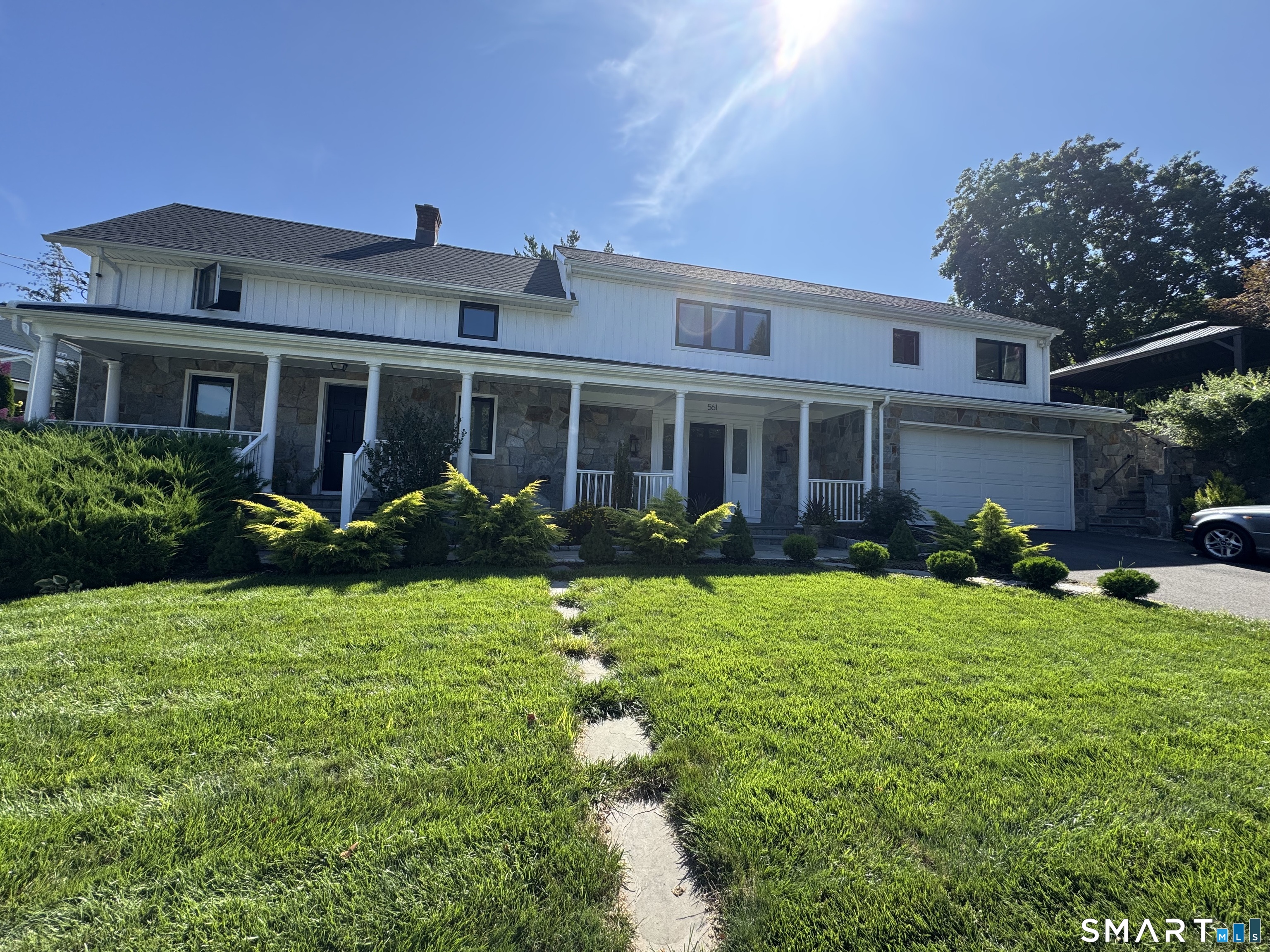 a front view of a house with garden and porch