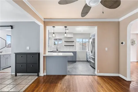 a room view with wooden floor and cabinets
