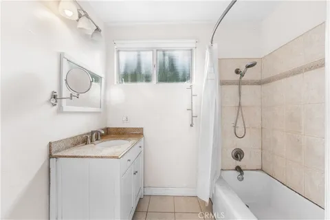 a bathroom with a granite countertop sink mirror vanity and toilet