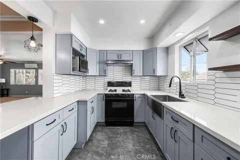 a kitchen with stainless steel appliances granite countertop a sink and cabinets
