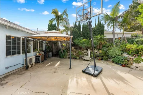 a view of a patio with a table and chairs under an umbrella