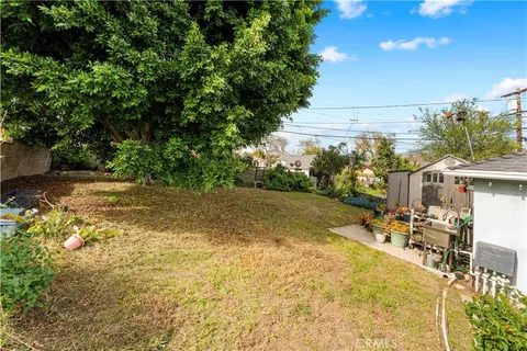 a swimming pool with outdoor seating and yard