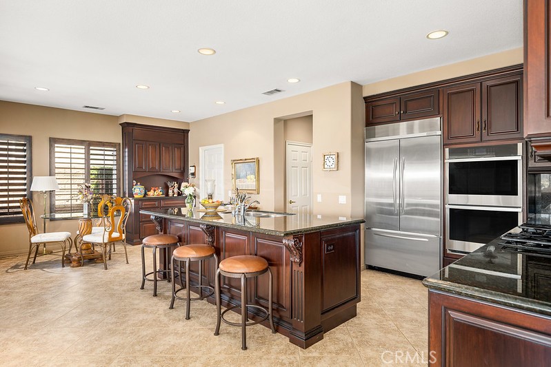 6962 Magdalena Drive Orange, CA 92867 - Photo 8 of 23 a kitchen with counter top space cabinets and stainless steel appliances