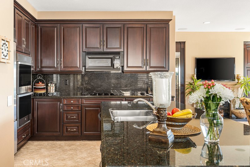 6962 Magdalena Drive Orange, CA 92867 - Photo 9 of 23 a kitchen with stainless steel appliances granite countertop a stove a sink and a microwave