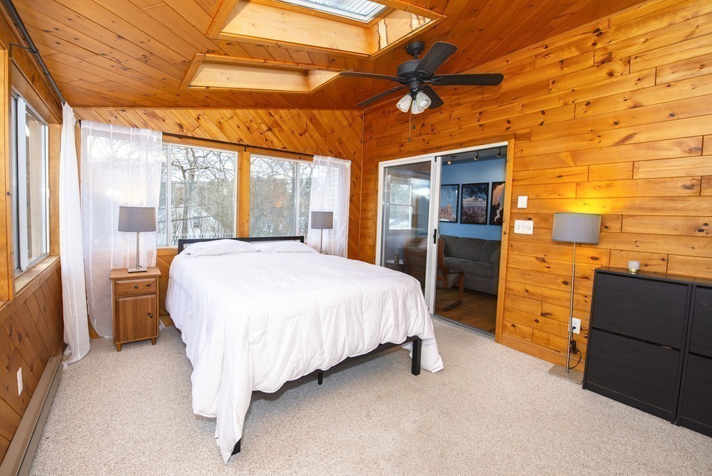63 Pine Street Natick, MA 01760 - Photo 12 of 19 a spacious bedroom with a bed and a dresser next to a window