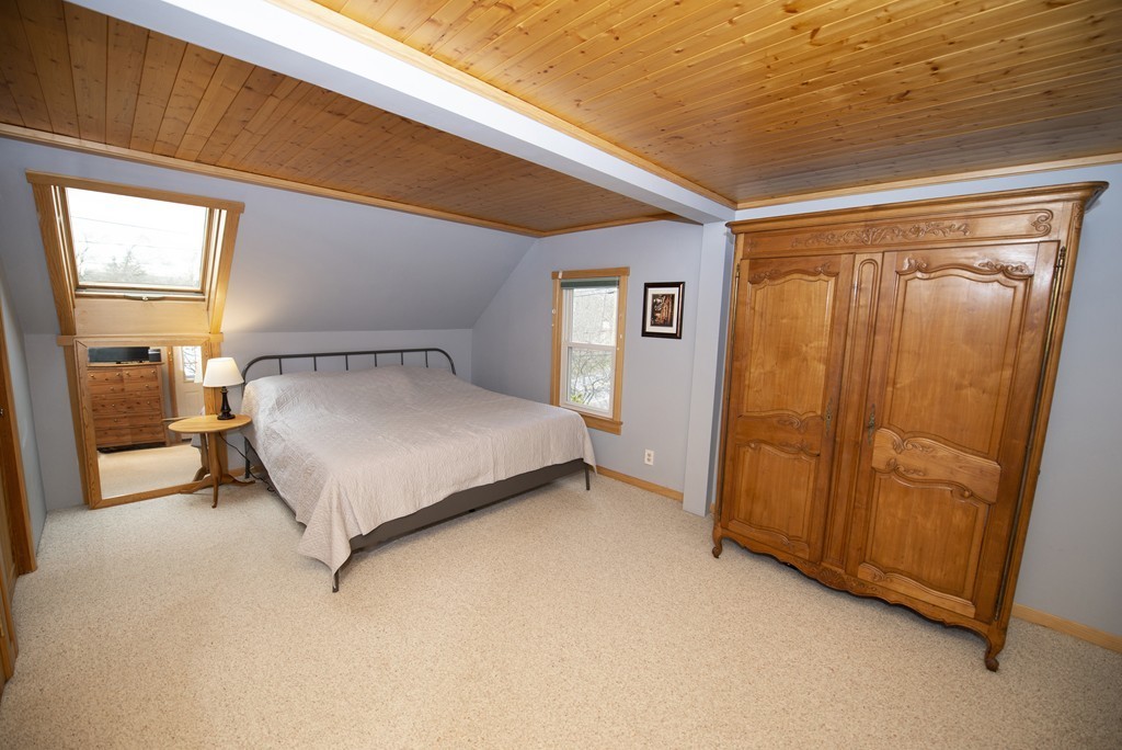 63 Pine Street Natick, MA 01760 - Photo 13 of 19 a bedroom with a bed and a mirror