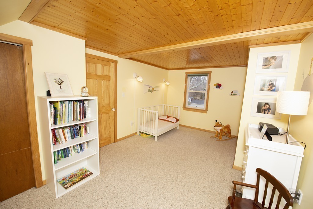 63 Pine Street Natick, MA 01760 - Photo 16 of 19 a view of a bedroom with workspace and a window