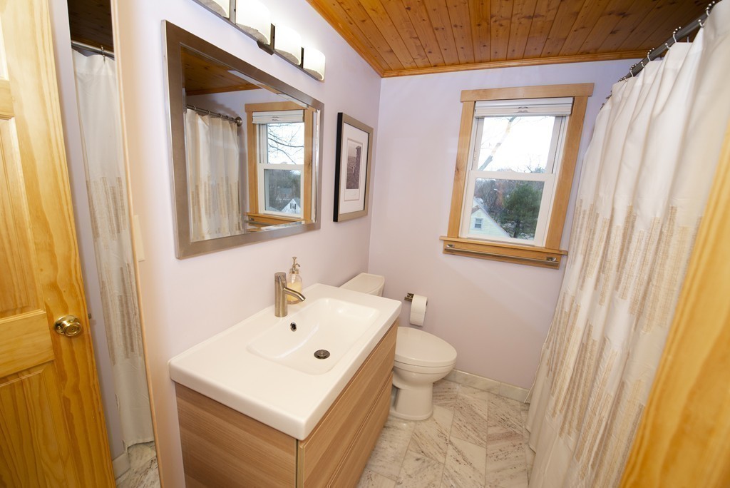 63 Pine Street Natick, MA 01760 - Photo 17 of 19 a bathroom with a toilet sink and mirror