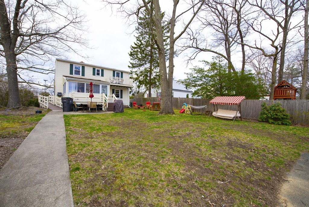 63 Pine Street Natick, MA 01760 - Photo 2 of 19 a front view of a building with a garden and trees