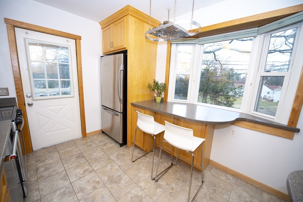 63 Pine Street Natick, MA 01760 - Photo 3 of 19 a view of a dining room with a table and chairs