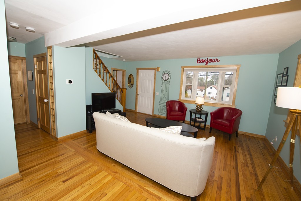 63 Pine Street Natick, MA 01760 - Photo 6 of 19 a living room with furniture and a wooden floor