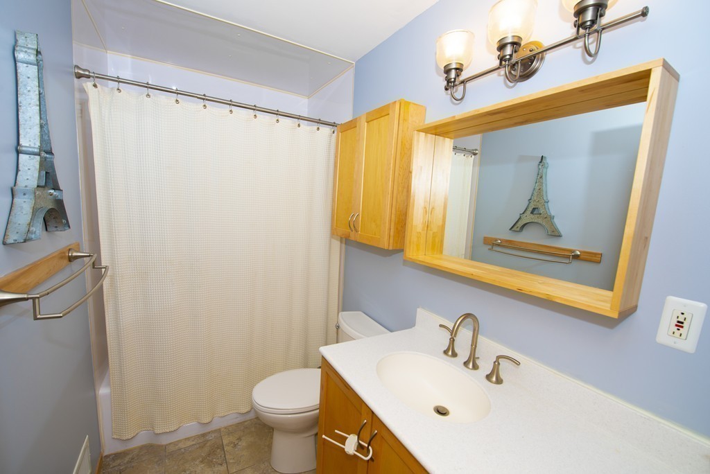 63 Pine Street Natick, MA 01760 - Photo 10 of 19 a bathroom with a sink mirror toilet and vanity