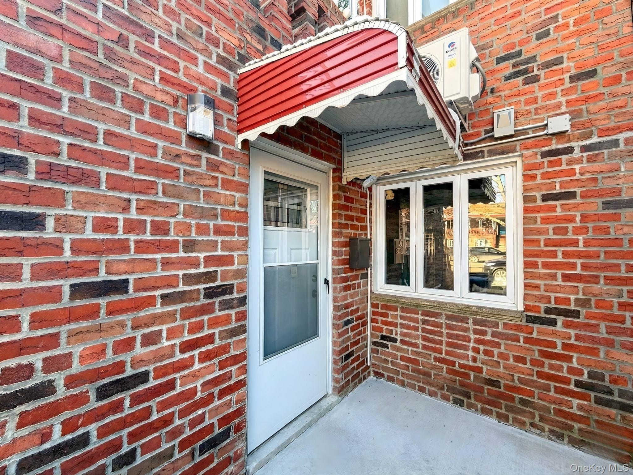 Doorway to property with brick siding