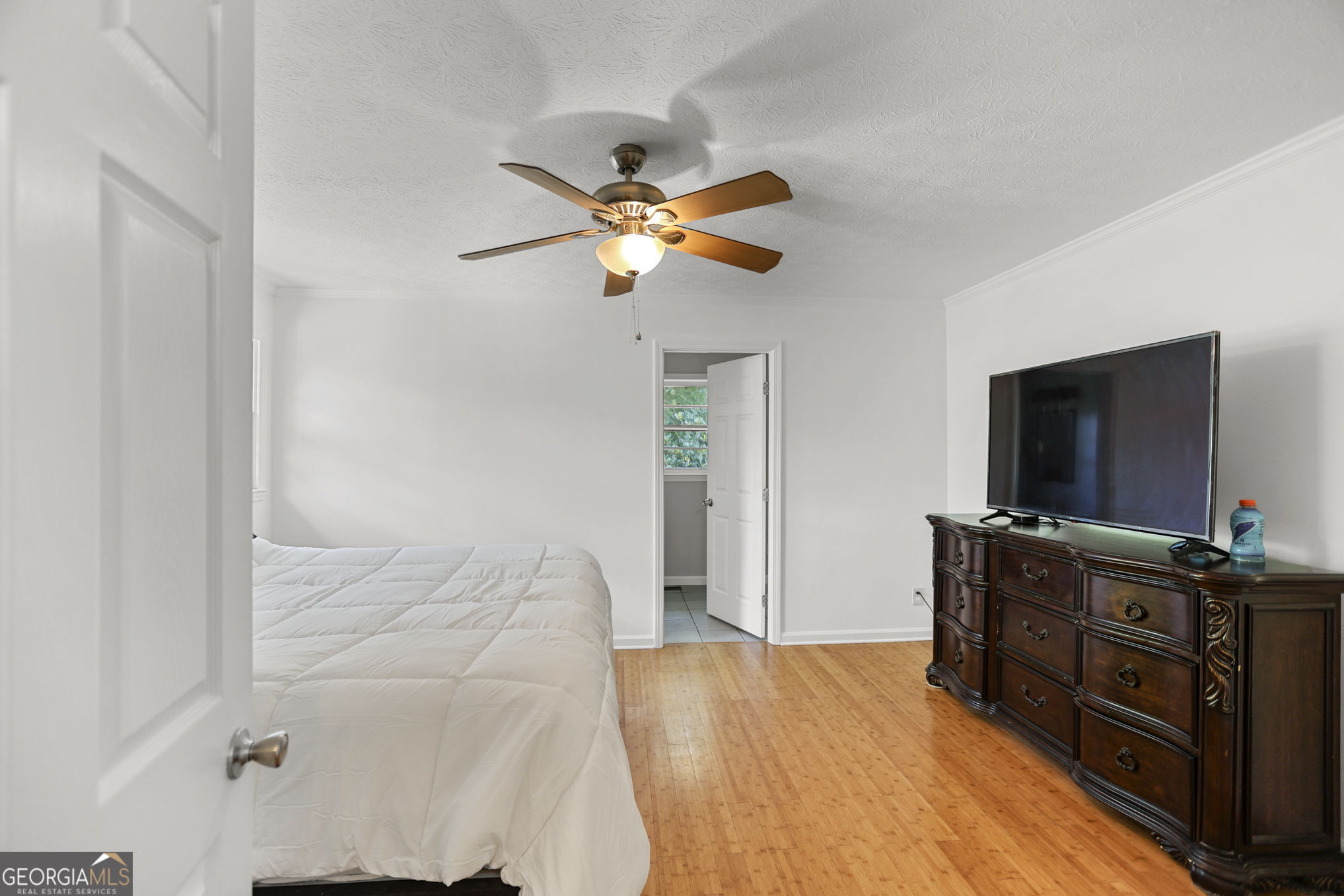 12 Conner Drive Newnan, GA 30263 - Photo 11 of 28 a bedroom with a bed and a flat tv screen on dresser