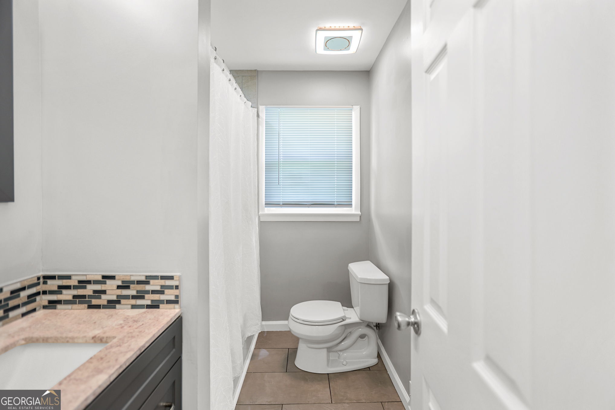 12 Conner Drive Newnan, GA 30263 - Photo 18 of 28 a bathroom with a granite countertop sink toilet and shower